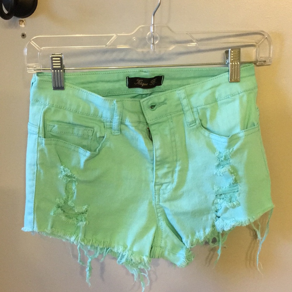 Mint high waisted shorts with rips.